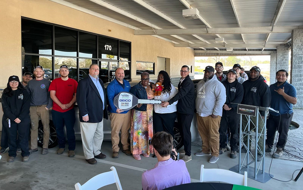 people gathered around the recipient of the NABC Recycled Rides Program vehicle presented in Lexington, SC on March 20, 2024