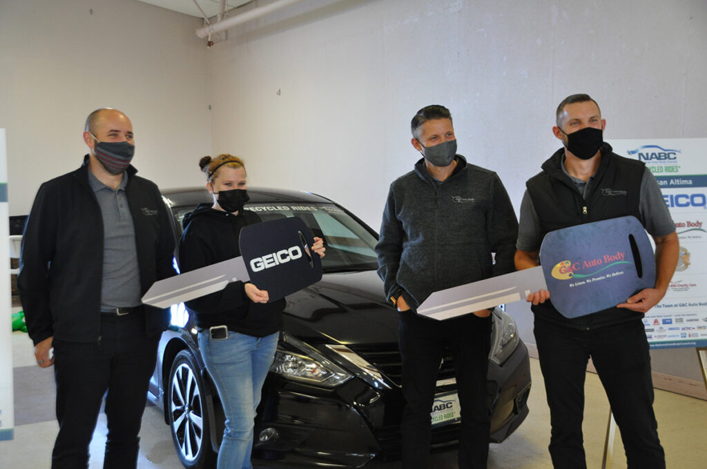 Vehicle recipients holding large keys with Geico and G&C logos