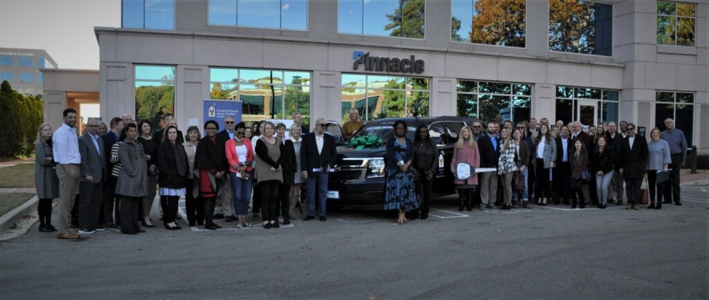 group of people at the RMHC vehicle presentation